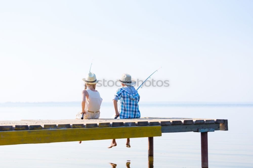 Similar – Image, Stock Photo Little boy on a dock sitting on his back looking to the ocean