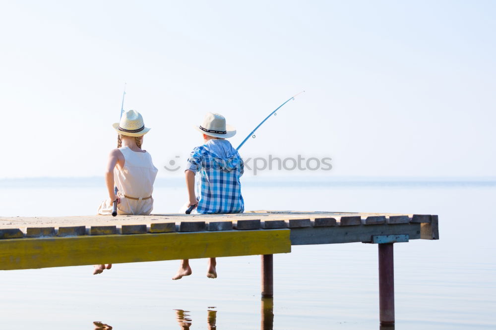 Similar – Image, Stock Photo Little boy on a dock sitting on his back looking to the ocean