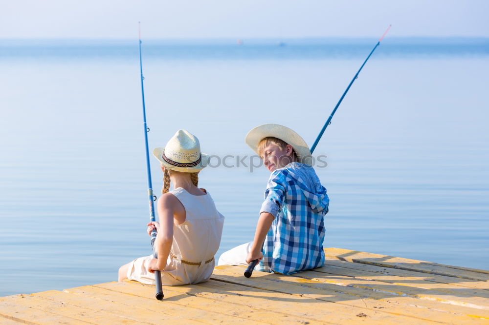 Image, Stock Photo Little boy on a dock sitting on his back looking to the ocean