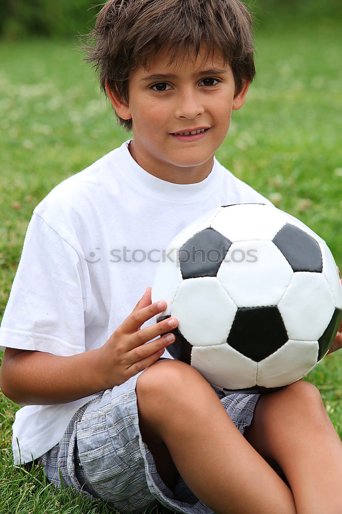 Similar – Portrait of a young boy with soccer ball. Concept of sport.