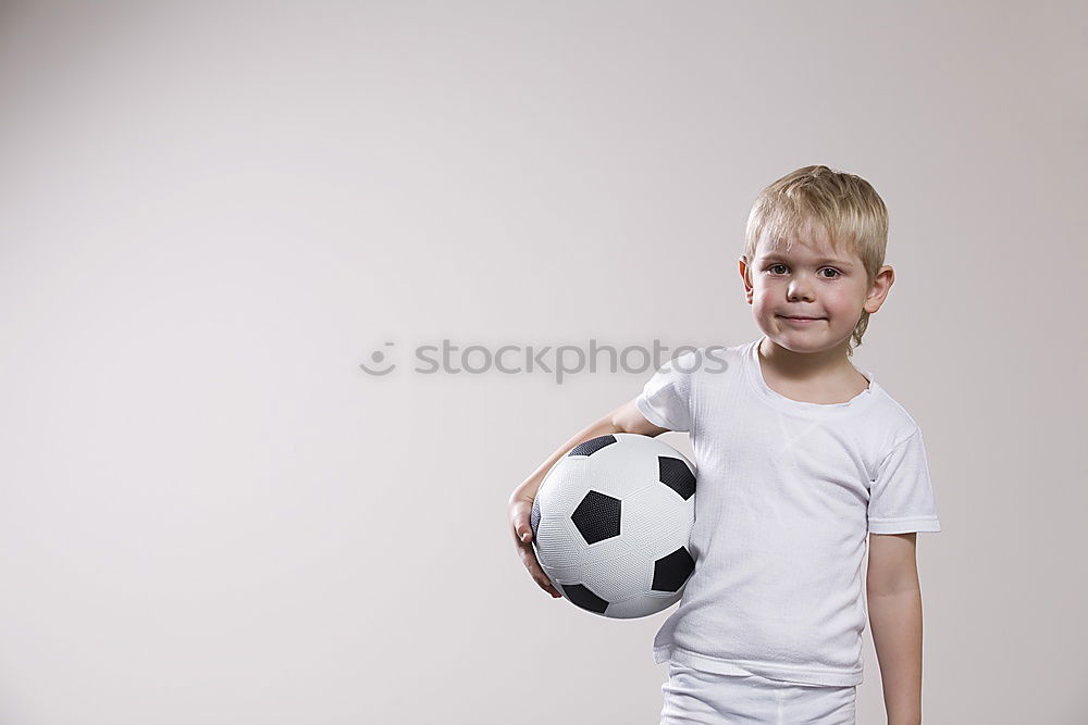 Similar – Portrait of a young boy with soccer ball. Concept of sport.