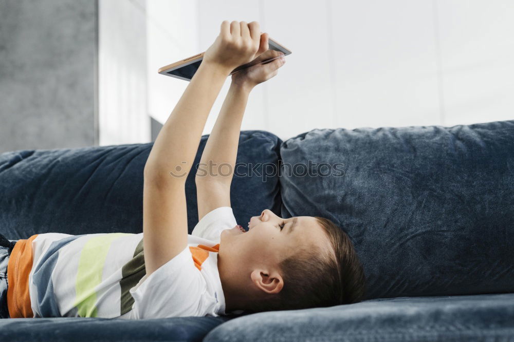 Similar – Image, Stock Photo little boy is lying on the bed and reading a book at the day time