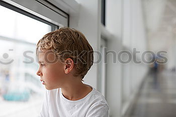 Similar – Image, Stock Photo Portrait of a young student leaning on wall while looking camera