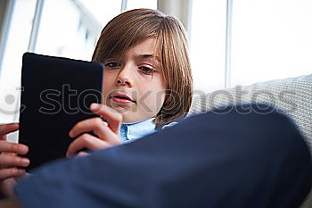 Similar – Sweet blondie girl playing on a Tablet PC.