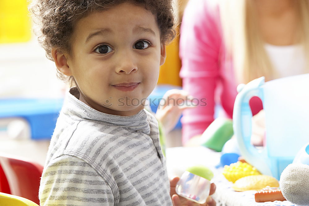 Happy baby playing with toy blocks.