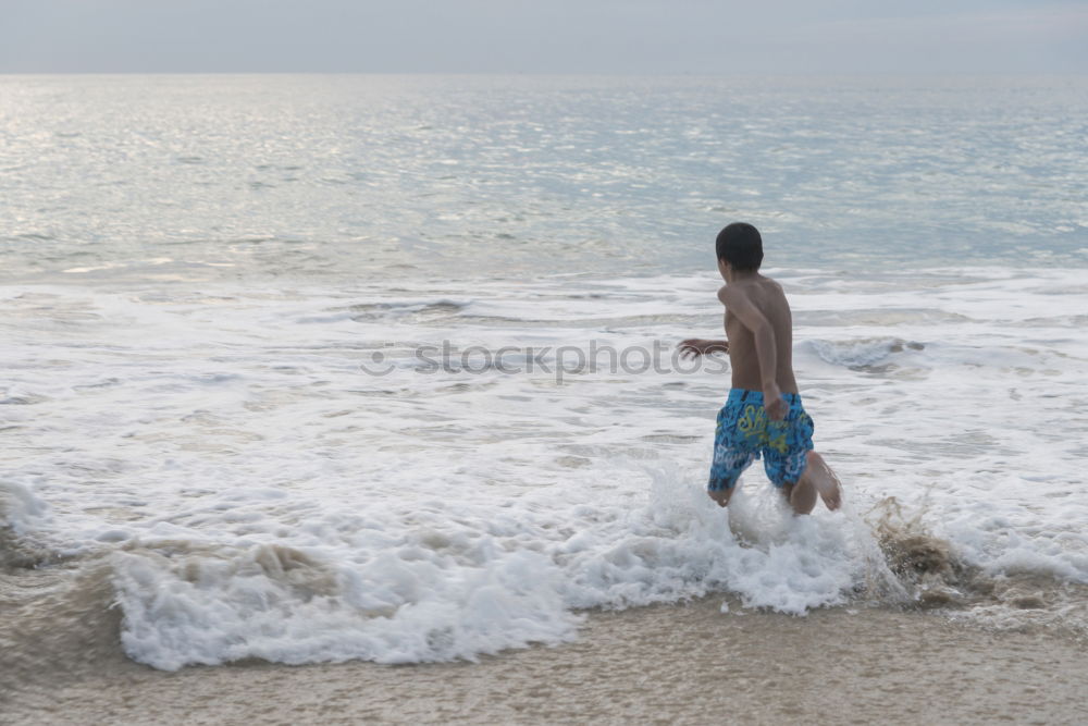 Similar – Man walking on the beach