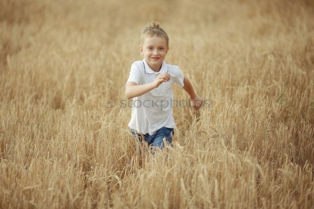 Similar – Little girl walking in nature field wearing beautiful dress