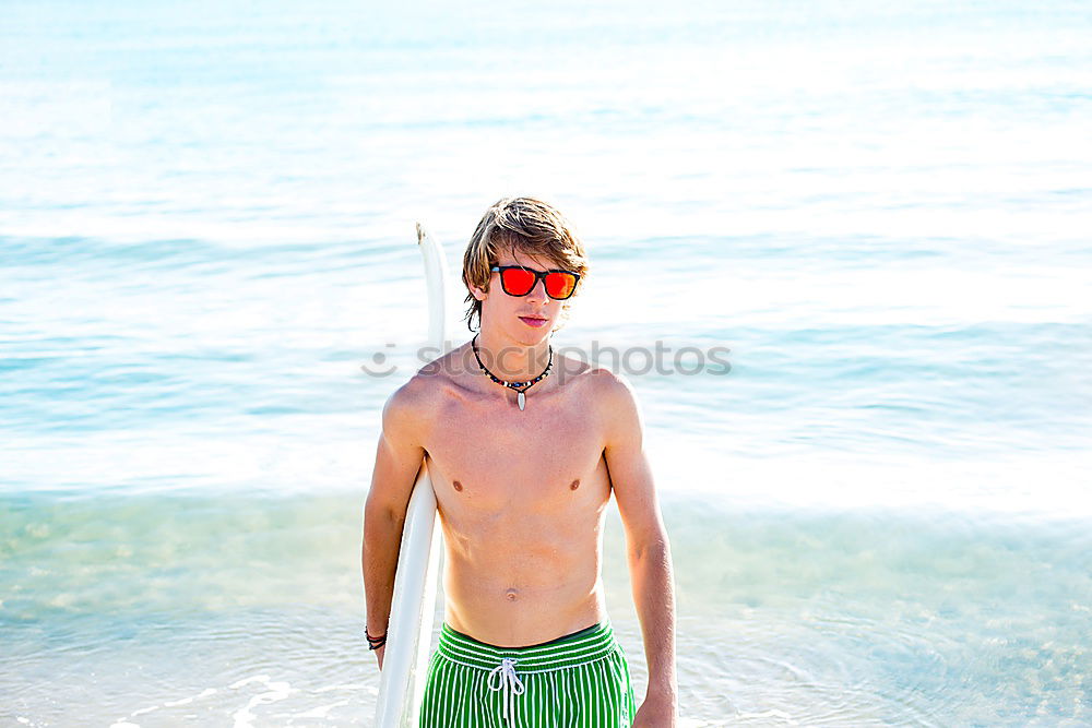 A man with a big belly in swimming trunks on the beach