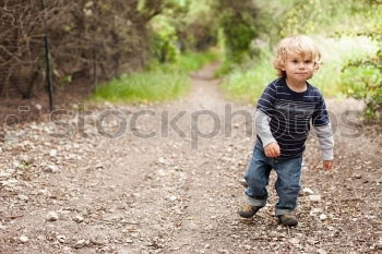 Similar – baby walking barefoot on stones