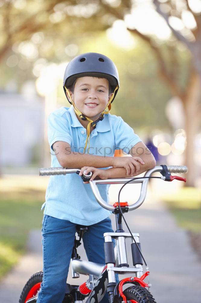 Similar – Cool gap | Portrait of a boy with a bicycle helmet and a tooth gap