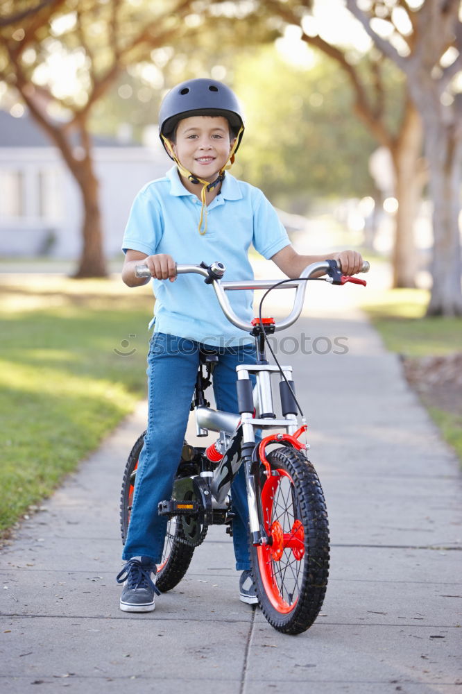 Similar – Image, Stock Photo Little kid riding his bicycle on city street
