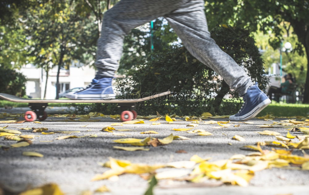 Similar – Ein junger Mann steht, während er seinen Fuß auf einem Skateboard hält.