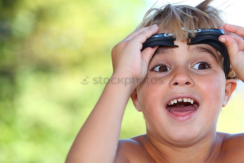 Similar – Funny, funny, cheerful, happy, funny blonde girl outside in the garden, looks up and sticks out her red tongue. Little joker is fooling around, fun with twisted eyes in nature, in the park with flowers and trees.