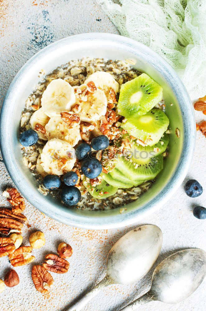 Similar – Image, Stock Photo Smoothie mango bowl with chia seeds yogurt pudding and cranberries, nuts, oatmeal topping in coconut shells with spoon. Healthy clean breakfast food. Copy space for your text or design