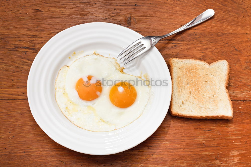 Similar – Fried egg face on wood