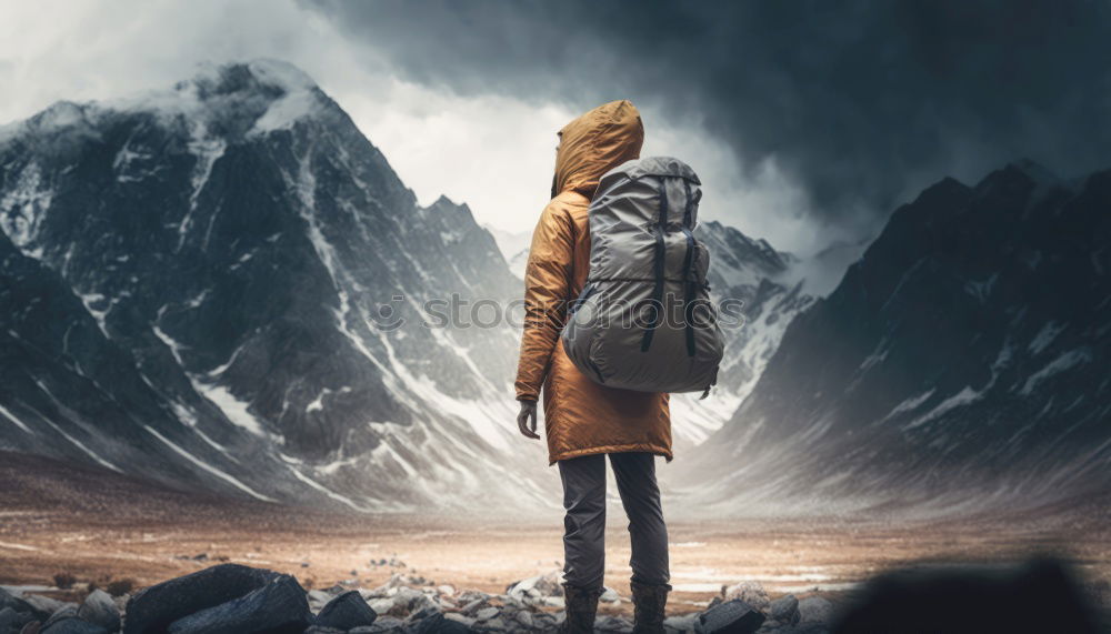 Similar – Couple against a night black sky with a narrow red and orange stripe in a snowy mountain landscape