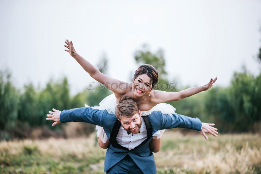 Similar – Image, Stock Photo Blonde woman and bearded man taking a walk embraced outdoors at sunset.