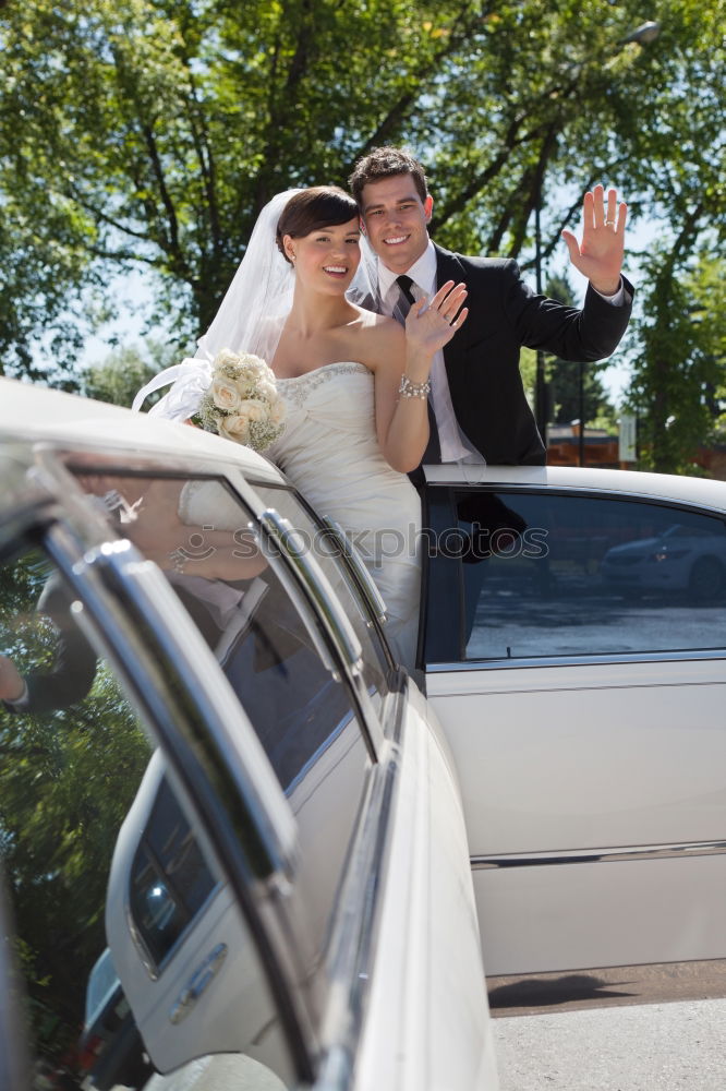 Happy day, bride and groom in the car.