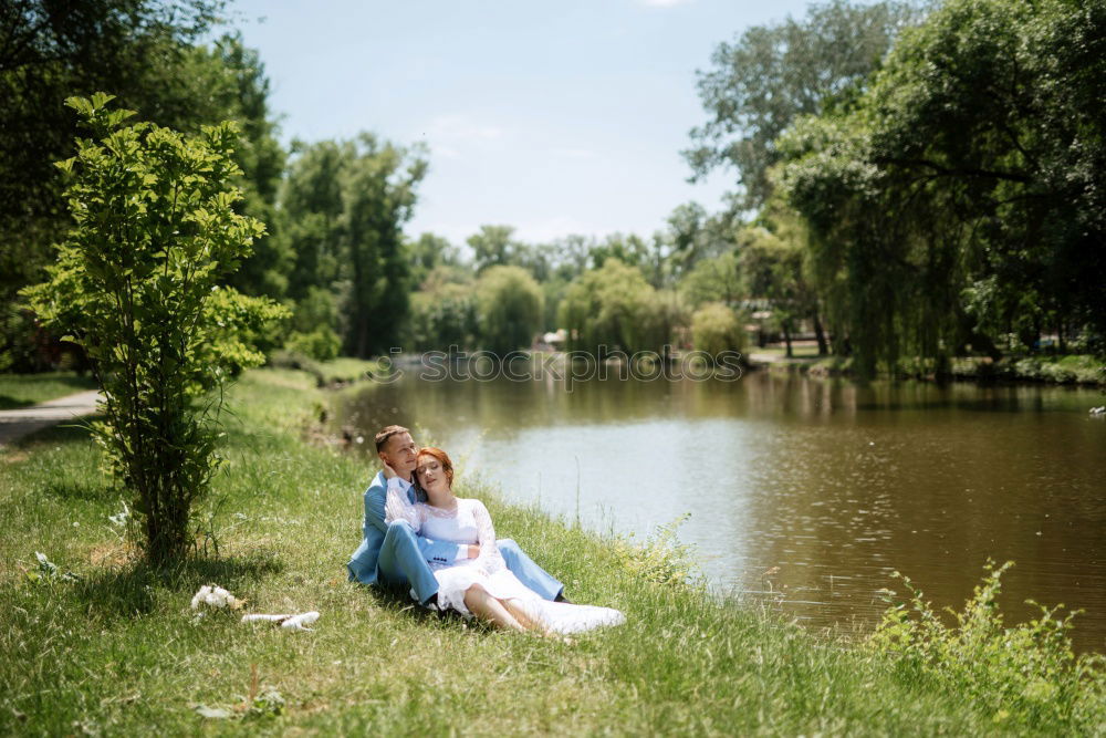 Similar – Image, Stock Photo analog medium format portrait of young woman in summer dress sitting barefoot among bushes in nature on a lakeside