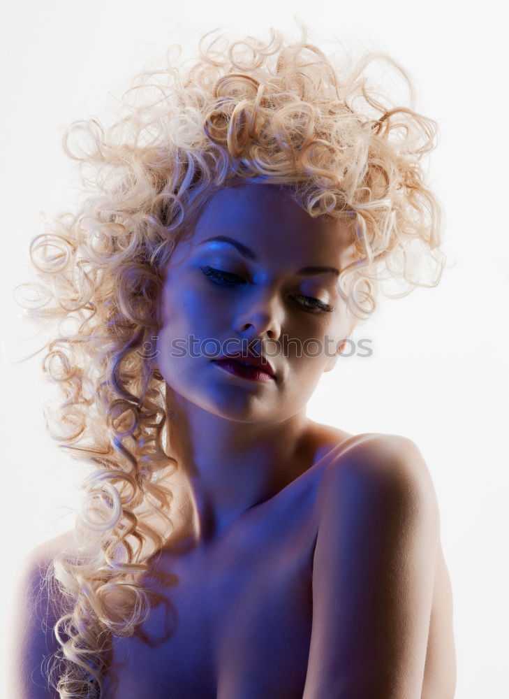 Profile shot of blonde long haired young woman with light eyes