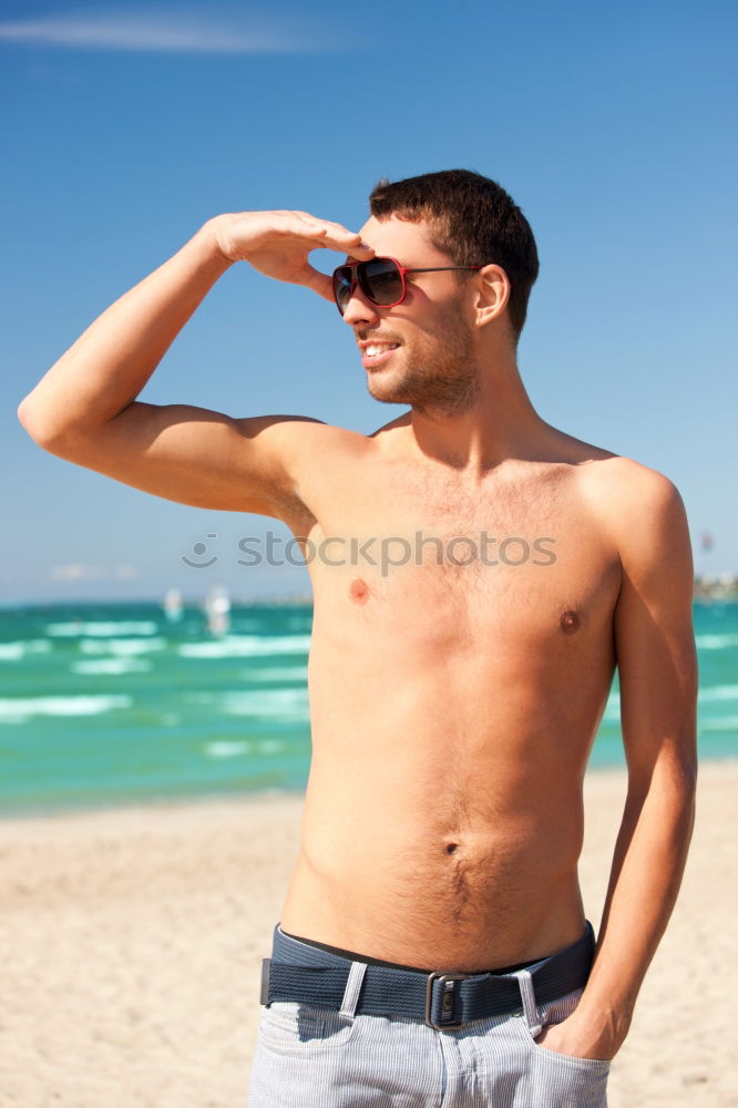 handsome swimmer putting on goggles