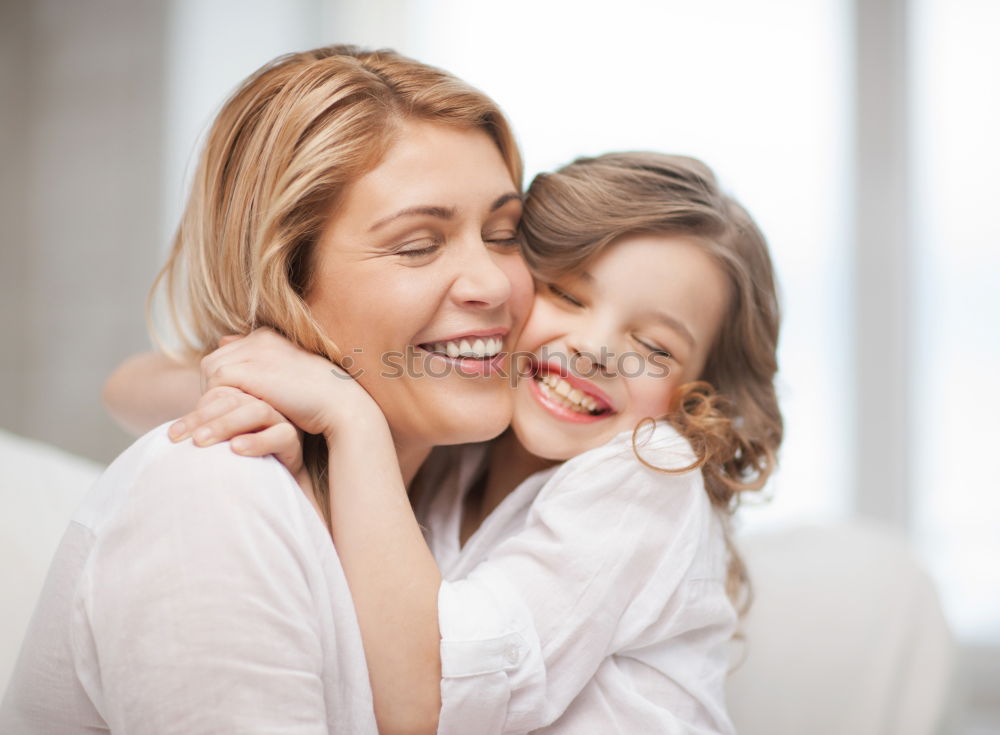 Similar – happy young mother and her baby boy lying on bed and smiling