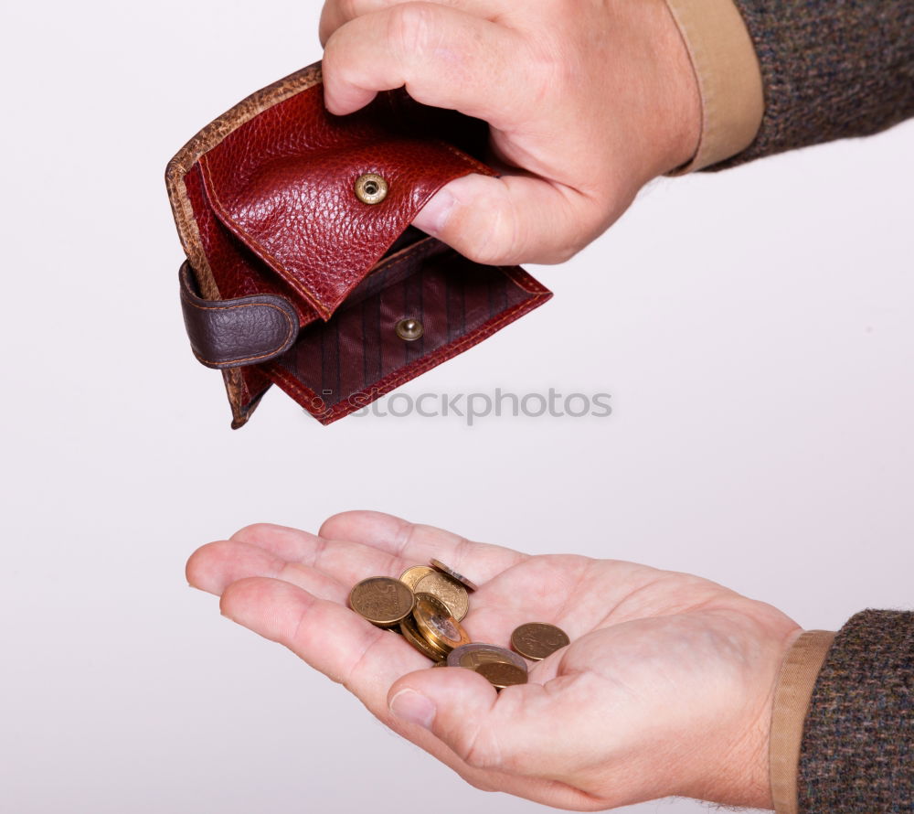 Similar – two female hands hold brown leather open empty wallet for cash