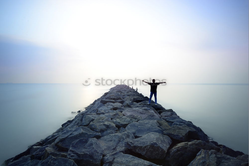 Anonymous man enjoying storm on pier