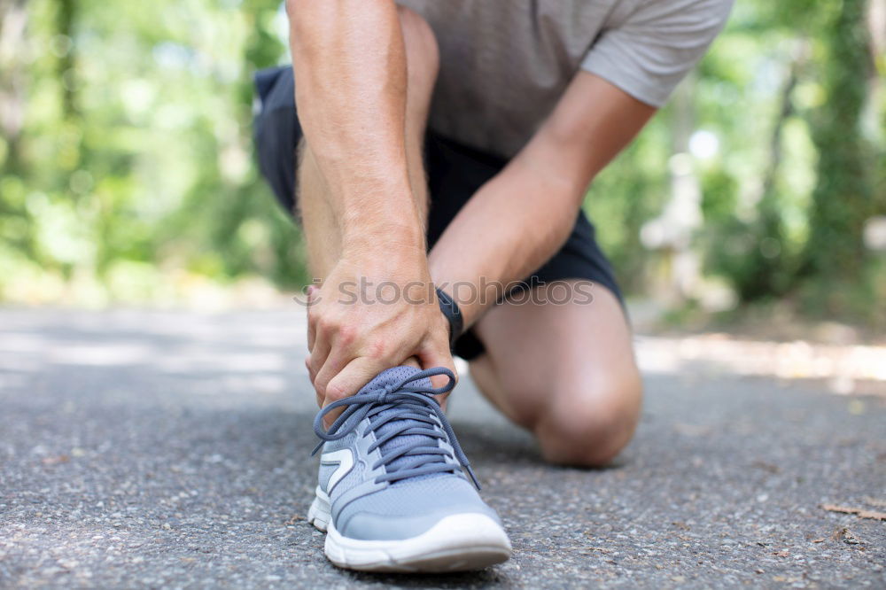 Similar – Runner get ready for run, tying sneakers shoelaces