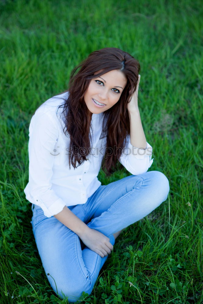 Similar – Young woman with freckles sits on a high flat roof in the evening light and smiles at the camera