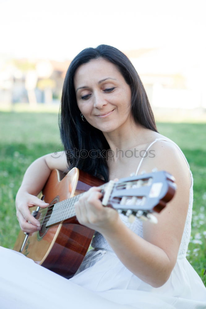 Similar – Mädchen spielt Ukulele im Gartenstuhl