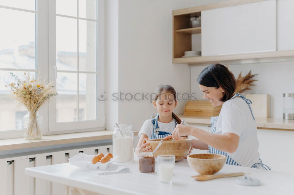 Similar – Image, Stock Photo little african girl is helping her mum preparing cupcake dough