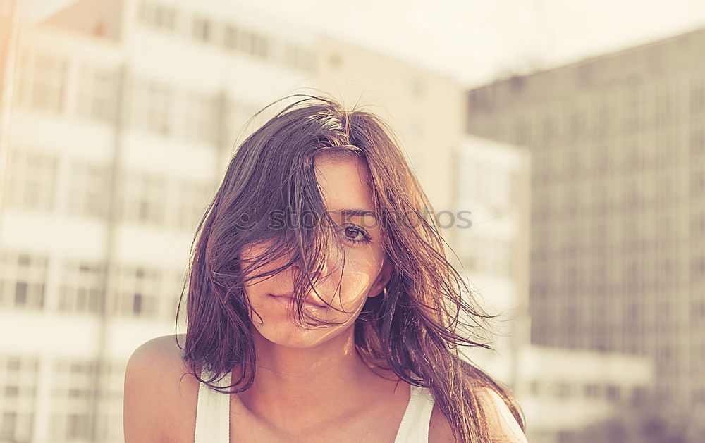 Similar – Cute woman touching her hair while the wind moves it.