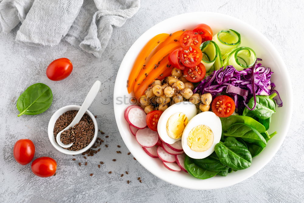 Vegan Buddha bowl with fresh raw vegetables and quinoa on wood