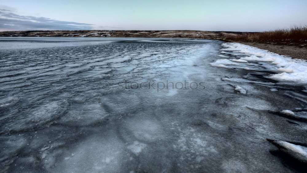 Similar – Half-frozen lake in idyllic winter landscape