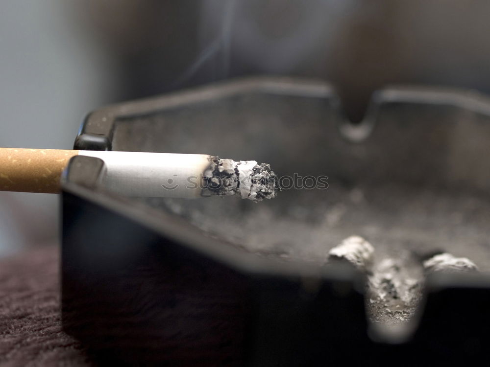 Similar – Image, Stock Photo A hand of a smoker with a burning cigarette and smoke, sprinkled with white paint