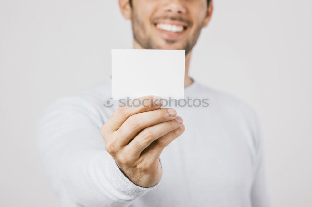 Similar – Portrait of a man showing a blank card.