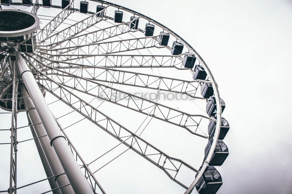 Bottom view of a ferris wheel against a clear sky