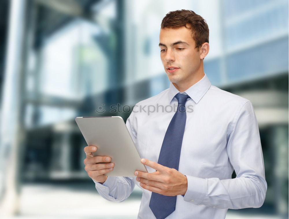 Similar – Image, Stock Photo Businessman enjoying coffee and checking his mobile phone for messages with a smile with his laptop and tablet open on the table