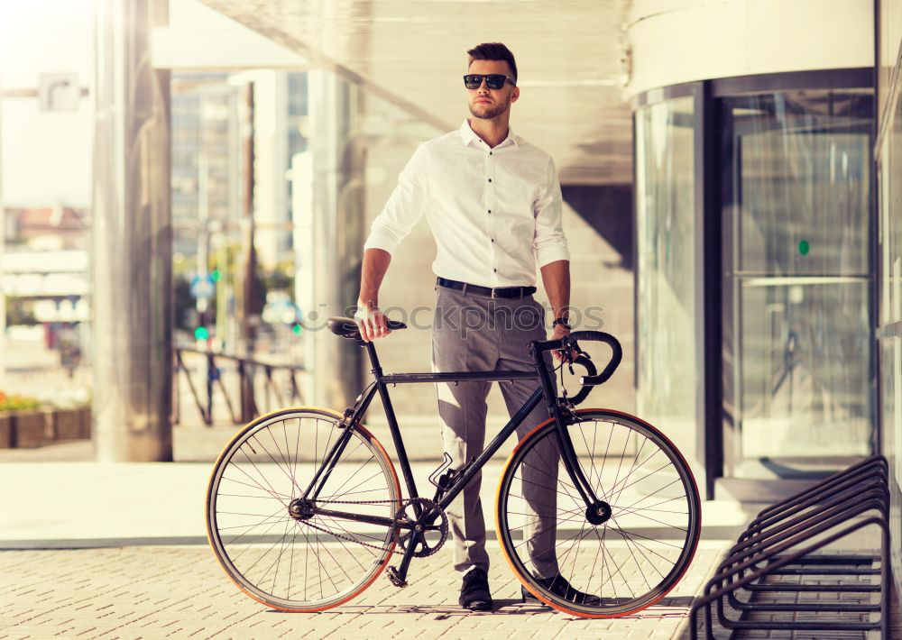 Similar – Image, Stock Photo Young man with mobile phone and fixed gear bicycle.