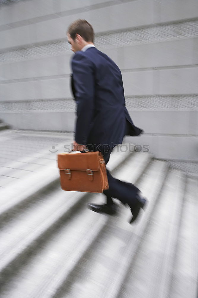 Similar – one person holds a leather travel bag in his hand