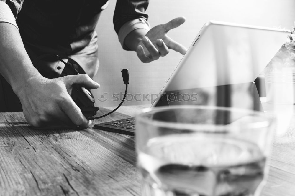 Similar – On a table there is a bottle of alcohol and a shot glass. A person’s hand is holding the shot glass.