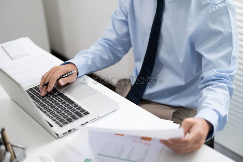 Similar – Young man works on a laptop in the start-up and listens to music through in-ear headphones