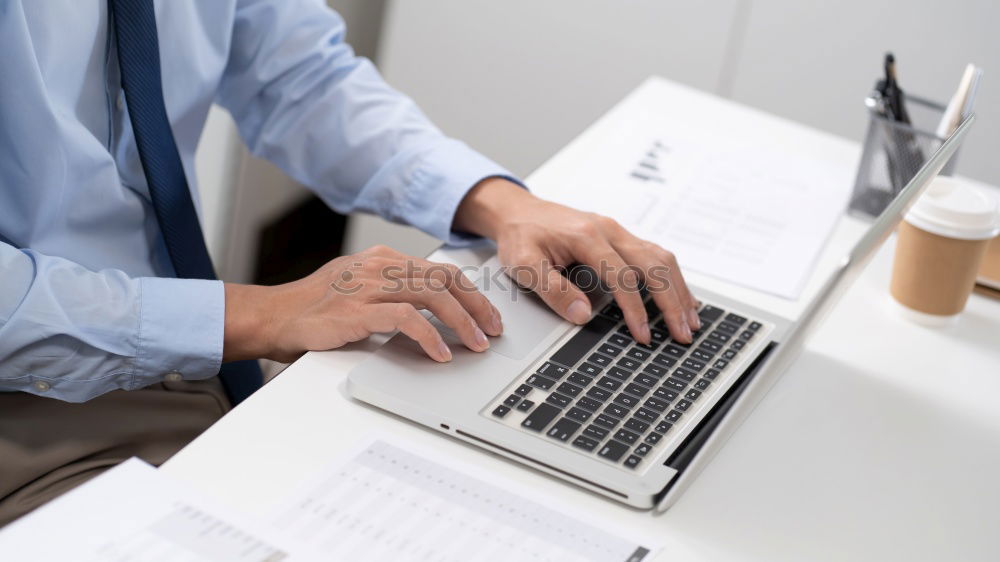 Similar – Young man works on a laptop in the start-up and listens to music through in-ear headphones