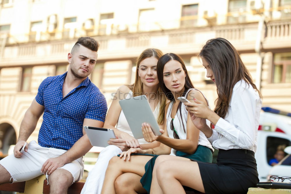 Similar – Multi-ethnic group of people looking at a tablet computer