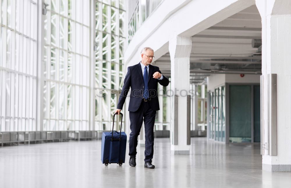 Similar – young businessman walking at the airport using his mobile phone