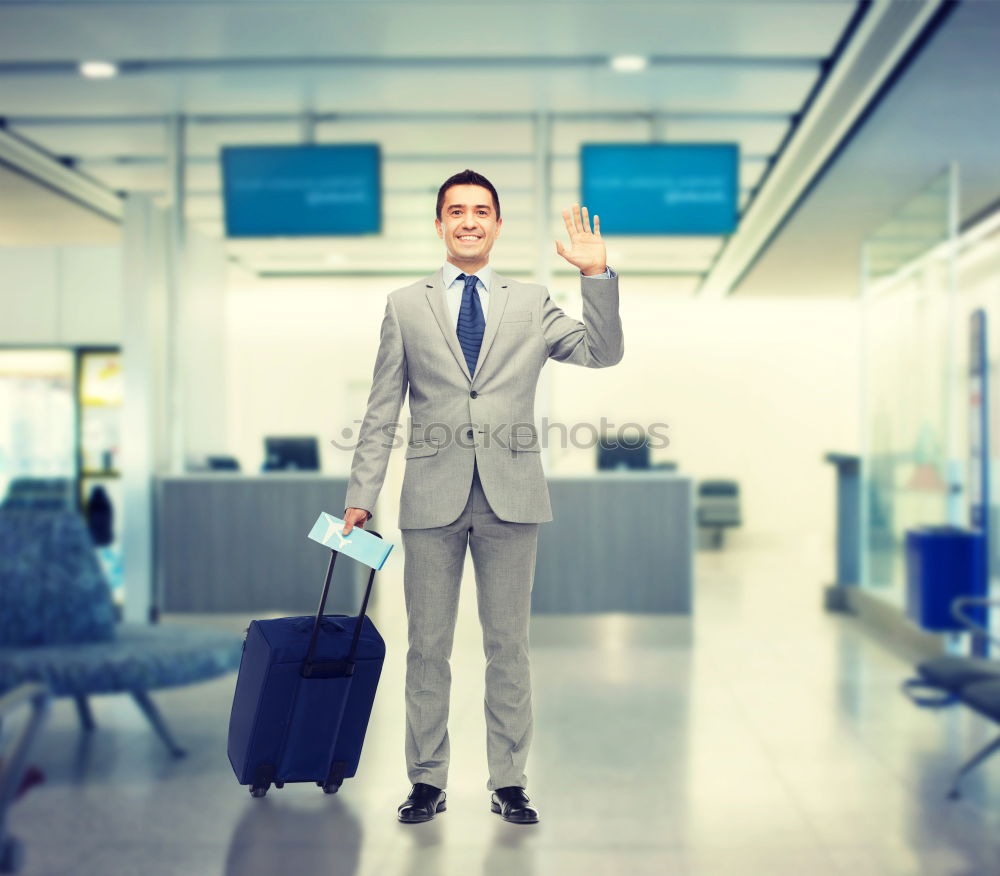 Similar – young businessman walking at the airport using his mobile phone