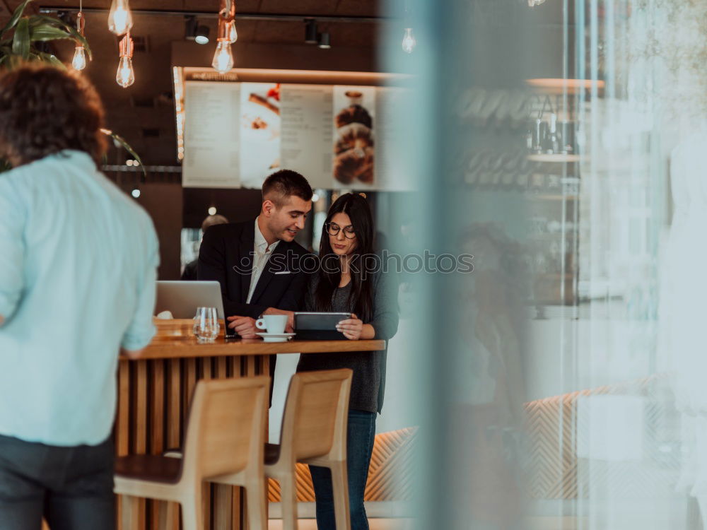 Young man receiving coffee at café