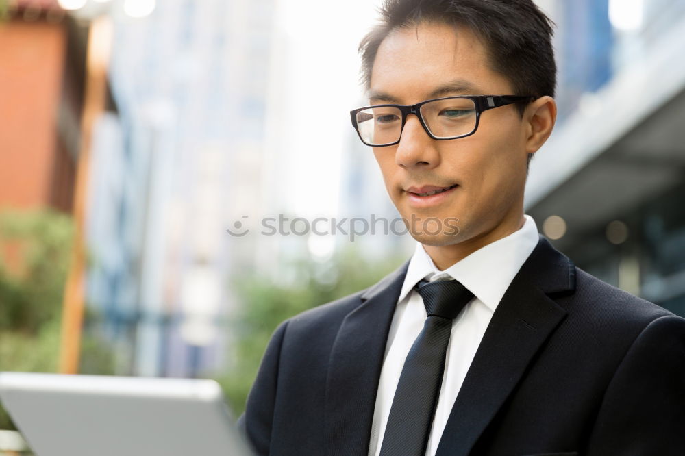 Image, Stock Photo Businessman enjoying coffee and checking his mobile phone for messages with a smile with his laptop and tablet open on the table