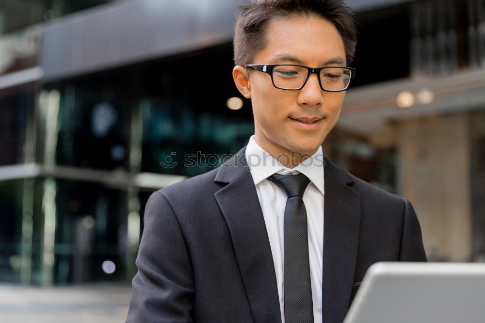 Similar – Image, Stock Photo Businessman enjoying coffee and checking his mobile phone for messages with a smile with his laptop and tablet open on the table